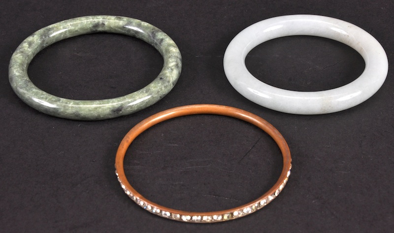 A CHINESE CARVED HARDSTONE CIRCULAR BANGLE together with another two bangles. Good condition. (3).