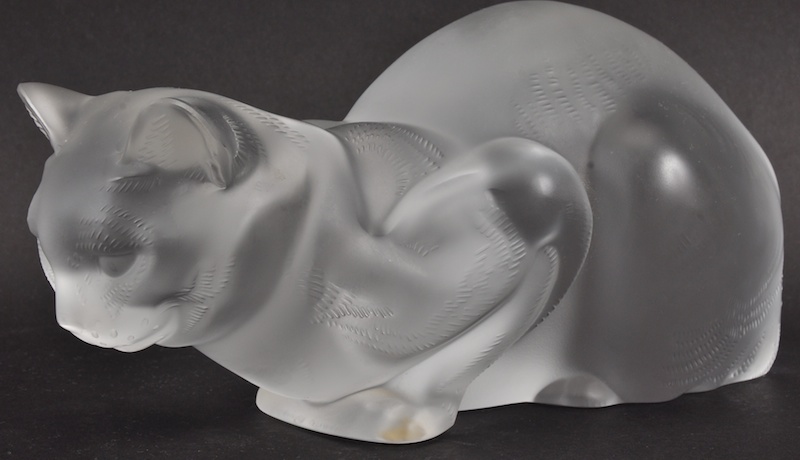 A LALIQUE MODEL OF A CROUCHING CAT. Engraved Lalique, France. 9ins long.