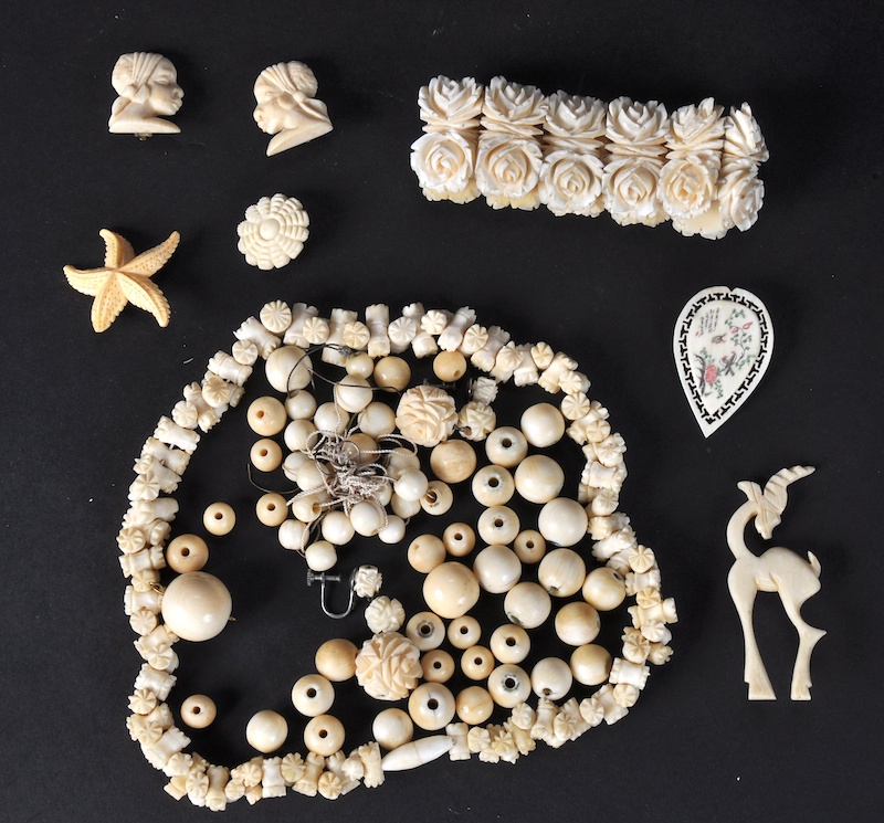 A BAG OF IVORY BRACELET AND NECKLACE.