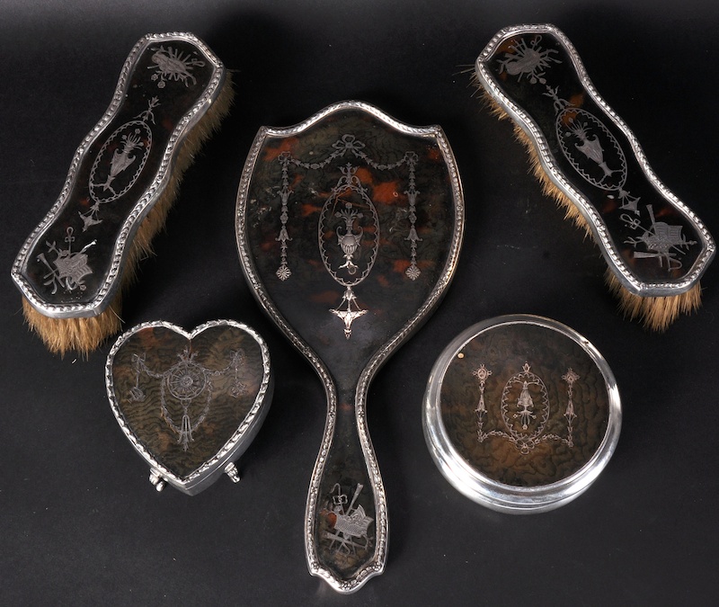A FIVE PIECE EDWARDIAN SILVER AND TORTOISESHELL TOILET SET comprising two boxes, hand mirror and two