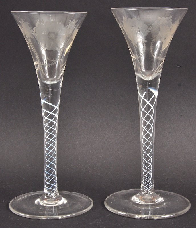 A PAIR OF GEORGIAN FLUTED WINE GLASSES, the bowls engraved with roses with air twist stems. 7.