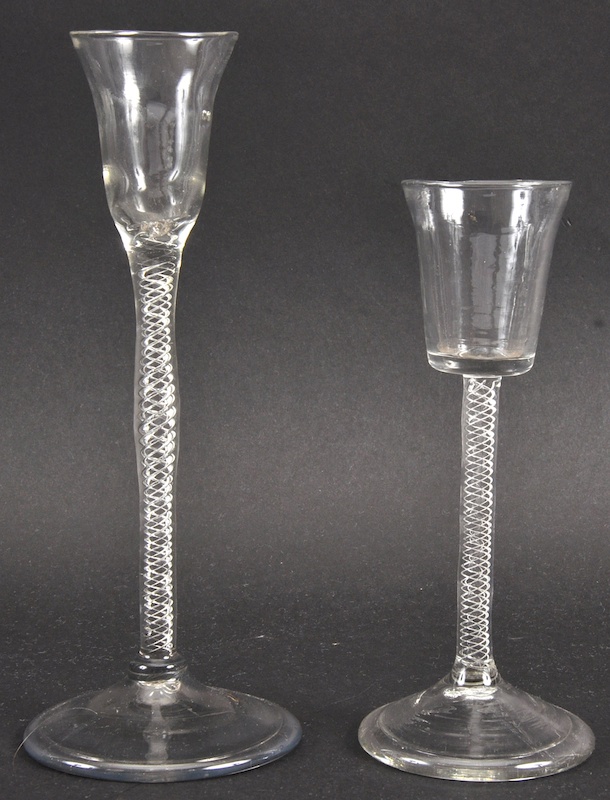 TWO SIMILAR GEORGIAN LIQUEUR GLASSES with air twist stems. 7.5ins and 5.75ins high.