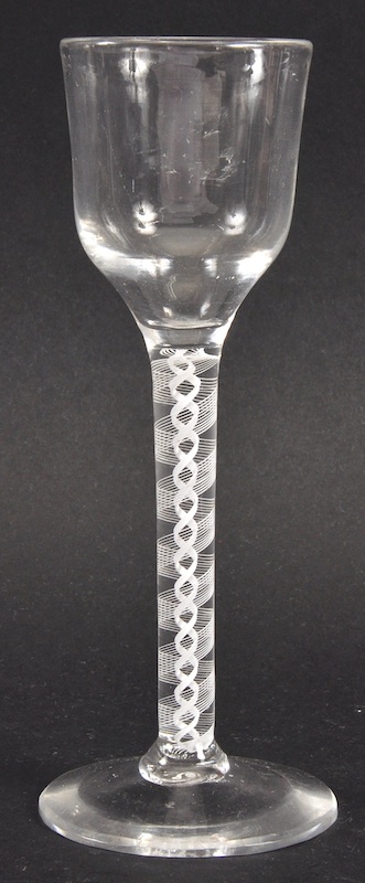 A GEORGIAN WINE GLASS with plain bowl and white opaque twist stem. 5.75ins high.