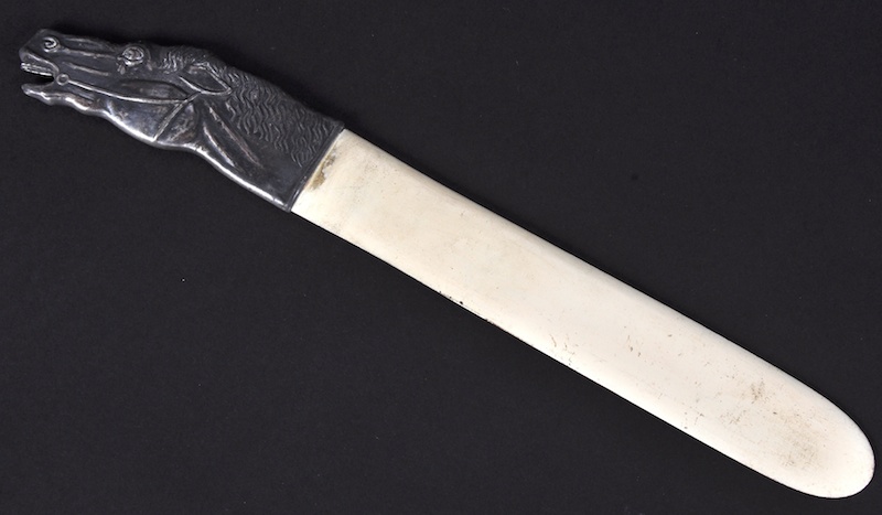 A RUSSIAN SILVER HORSES HEAD AND IVORY LETTER OPENER.