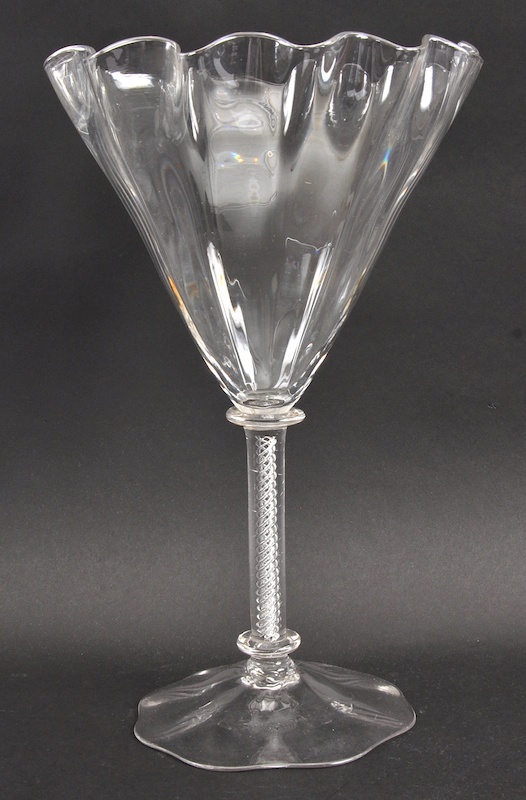 A TALL FLUTED GLASS OR VASE with air twist stem.