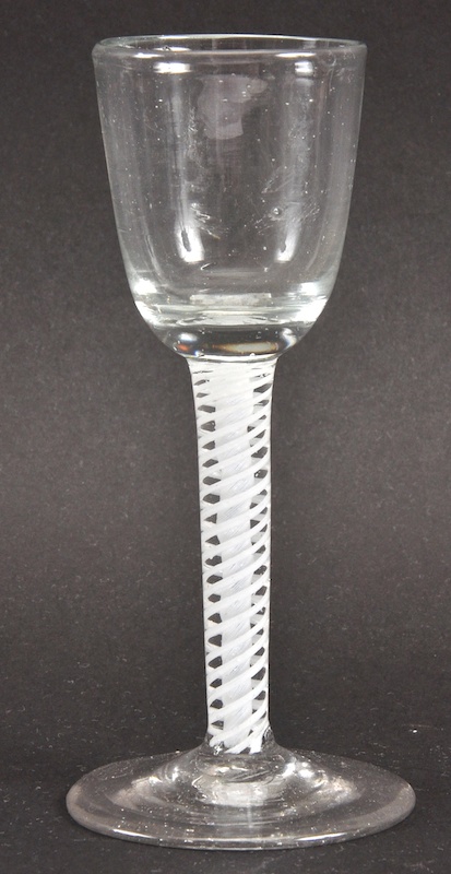 A GEORGIAN WINE GLASS with plain bowl and white opaque twist stem. 5ins high.