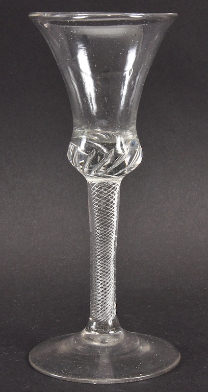 A GEORGIAN WINE GLASS with inverted bell shaped bowl and air twist stem. 6.5ins high.