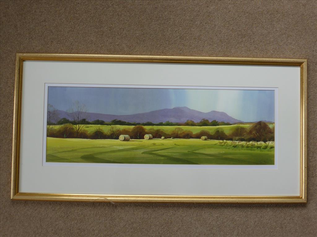 TIM NASH, WATERCOLUR, `AMONGST THE HAY BALES, THE MALVERNS FROM SHUTHONGER` APPROX. 28 X 9.5 INS.