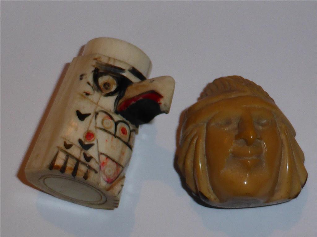 NUT CARVED IN THE FORM OF A NATIVE AMERICAN INDIAN AND A IVORY/ BONE PEPPER POT IN THE FORM OF A