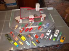 Model car garage marked 'Julian & Co service station' with lg quantity of Dinky, Corgi & Matchbox