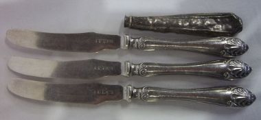 3 silver butter knives and a silver handle - approx wt 2.6 oz
