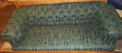 Old re-upholstered green Chesterfield sofa