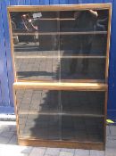 Dark oak bookcase with glass sliding doors