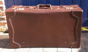 Large leather suitcase with canvas cover