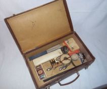 Sm. leather suitcase containing spectacles, tape measure, fan, desk clock, matchbox holder, Parker