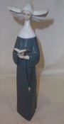 Lladro figurine of a nun with book