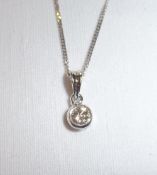 18ct gold pendant set with diamond on 18ct white gold chain