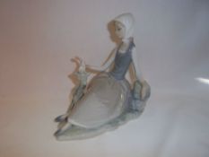 Lladro figurine of seated young girl with bird