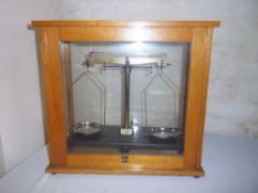 Set of Giffin George precision scales in display cabinet marked Phillip Harris Birmingham