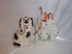 Staffordshire flatback with Highland gentleman & lady over a painted clock & Staffordshire dog