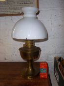 Brass paraffin lamp with opaque glass shade