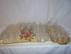 50 Webb Corbett cut glass drinking glasses with matching jug (sets of 10 each) on two trays