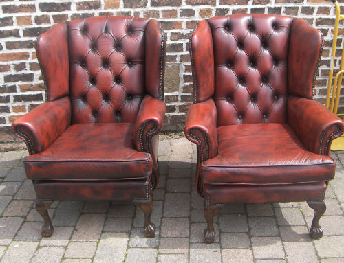 Pr of red leather Chesterfield style wing chairs