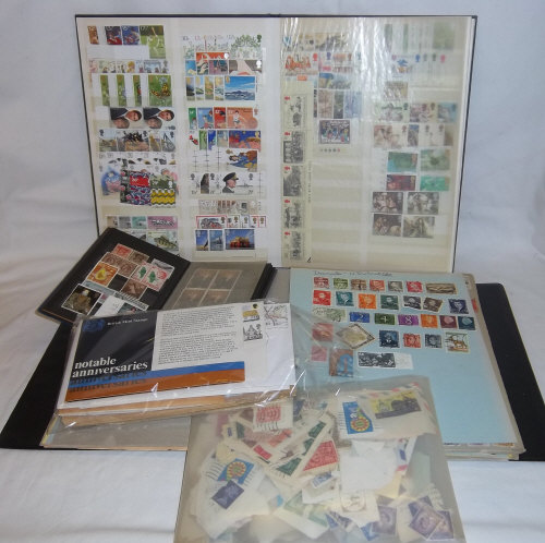 Stock album of mint GB stamps, album foreign stamps & packets & sel. FDC