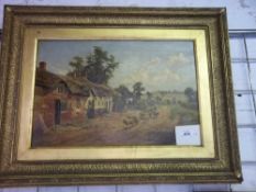 Gilt framed oil on board of thatched cottages in a clearing signed by the artist Jack M. Ducker (