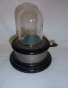 Vintage gaming device comprising two dice under glass dome with brass topped button to flick dice on