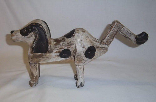 Carved wooden toy dog with jointed legs & tail