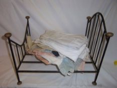 Doll`s wrought iron double bed & sel. vintage dolls clothes