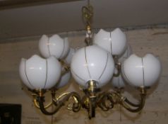 Brass chandelier with opaque glass shades