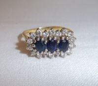 18ct gold 3 stone sapphire ring set with diamonds