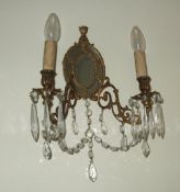 Pr gilt metal twin light wall appliques with mirrored back plate issuing scrolling arms & cut