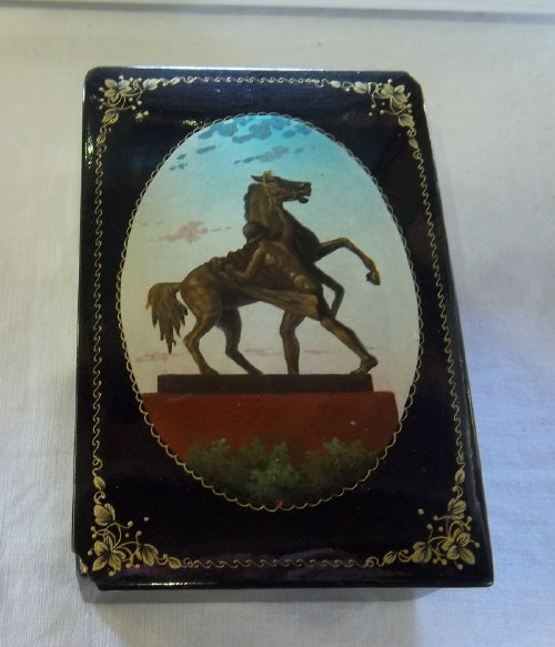 Russian lacquered box with hand-painted panel to lid & gilt border