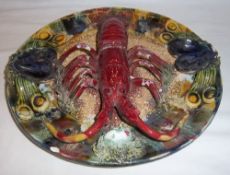 Palissy style plate centrally modelled with a lobster on a naturalistic seabed ground dia. approx.