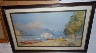 Framed watercolour depicting mountainous landscape with lake in foreground signed by the artist