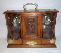 Oak tantalus with 2 glass decanters & central cupboard