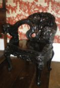 Chinese open armchair with heavily carved dragon decoration & ivory inlaid eyes