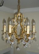 Gilt chandelier with scrolled supports & 6 faux candle lights with glass droplets & daisies -