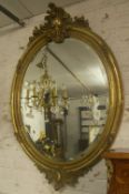 Gilt oval mirror with floral dec. (damaged)