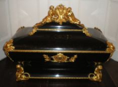 Large black casket decorated with 2 gilt figures flanking cartouche marked A P and further elaborate