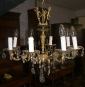 Gilt metal chandelier with clear glass droplets & cherub decoration