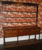 Geo. oak dresser with open plate rack, 5 drawer base over panelled pot board, width approx. 194cm