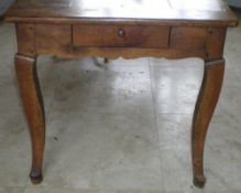 French farmhouse kitchen table with four plank top and cleated ends above a shaped frieze with