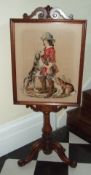 Vict. mah. fire screen with embroidered panel depicting cavalier & his spaniel on tripod base