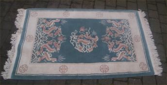 Chinese wool rug on green ground size approx. 158cm x 95cm