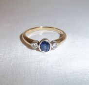 9ct gold ring set with central sapphire & 2 diamond chips