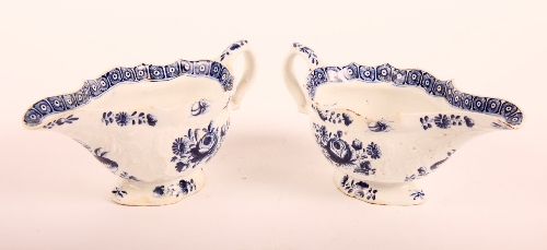 A pair of Worcester First Period blue and white sauce boats decorated floral posies (restored)